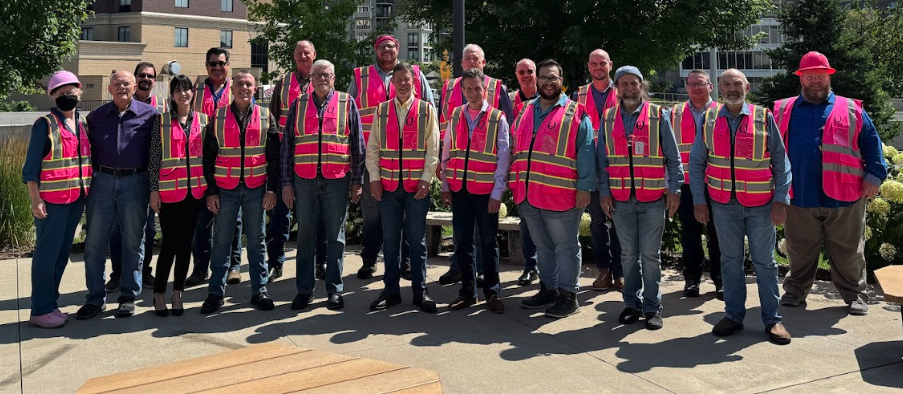 Group photo of Quarryland Men's Chorus wearing pink vests before their 2024 GALA Festival concert in Minneapolis.